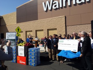 Walmart employees, and officials from both cities and the Brazos Valley Food Bank unveil a check for $150,000. The BVFB reached 40% of their $4.1 million capital campaign goal to expand their warehouse.