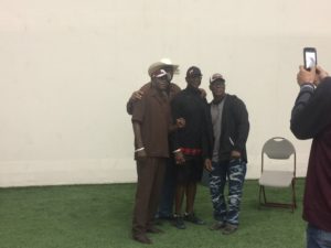 (Former NFL RB Eric Dickerson (middle) takes a picture with fans)