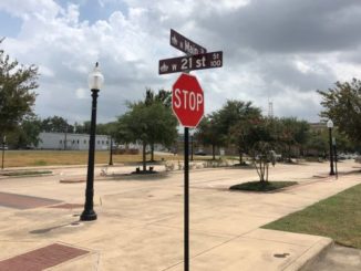 A street sign at the intersection of 21st and Main in Bryan, where there is a petition drive to change the name of 21st Street to Carey Cauley Jr. Street.