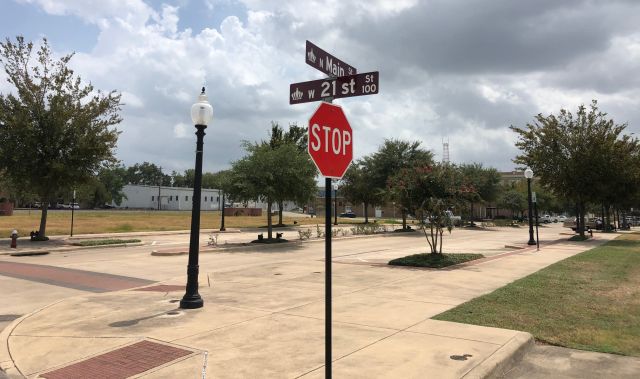 A street sign at the intersection of 21st and Main in Bryan, where there is a petition drive to change the name of 21st Street to Carey Cauley Jr. Street.