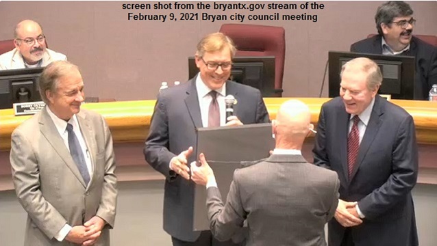 Screen shot from the bryantx.gov stream of the February 9, 2021 Bryan city council meeting, showing (L-R) Texas A&M system chancellor John Sharp, Bryan mayor Andrew Nelson, and A&M system board of regents member Phil Adams. Facing Sharp, Nelson, and Adams is Bryan deputy city manager Hugh Walker.