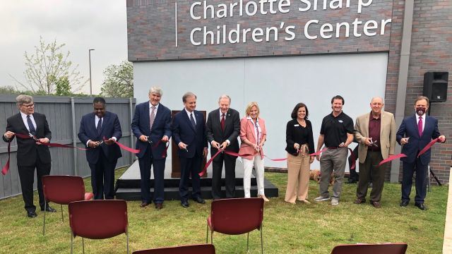 Ribbon cutting outside the Charlotte Sharp children's center, April 9 2021.