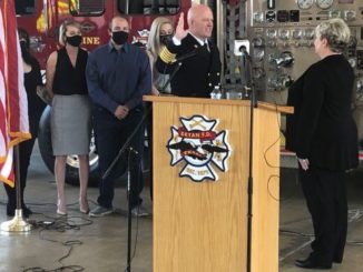 Swearing in of new Bryan fire chief Richard Giusti by Bryan city secretary Mary Lynne Stratta with Guisti's family, April 1 2021.