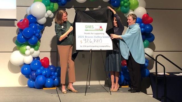 (L-R) Brazos Valley Gives co-chairs Julie Porter and Molly Watson and Community Foundation of the Brazos Valley president Patricia Gerling unveil the total given to participating agencies on November 30, 2021.