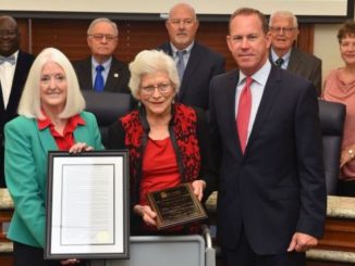 Photo courtesy of Blinn College. Front row (L-R) chancellor Mary Hensley, Teddy Boehm, and trustees chairman Jim Kolkhorst. Rear row (L-R) Trustee members Randy Wells, Douglas Borchardt, Dennis Crowson, Charles Moser, and Allison Bentke.