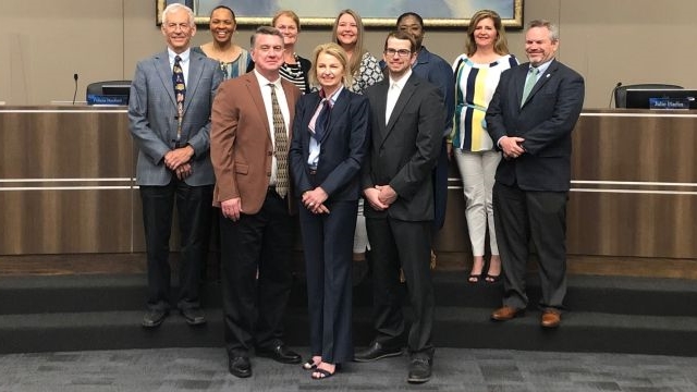 Front row (L-R) Mike Carrabine, Ginger Carrabine, and Andy Carrabine. Back row (L-R) Bryan ISD school board members David Stasny, Felicia Benford, Ruthie Waller, Fran Duane, Deidra Davis, Julie Harlin, and Mark McCall.