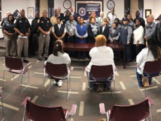 Panoramic photo of corrections officers and employees receiving a proclamation from Brazos County commissioners on April 26, 2022.