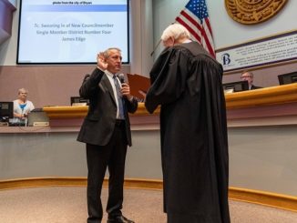 Photo from the city of Bryan of (L) James Edge being sworn in as single member district four councilman by (R) Texas 10th district court of appeals justice Steve Smith.