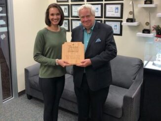 (L-R) Destination Bryan community engagement manager Katelyn Brown and Bryan Broadcasting vice president Ben Downs holding the award from the Texas Downtown Association, November 8 2022.