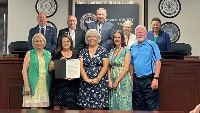 Brazos County photo from the county commission's July 25, 2023 meeting showing commissioners and representatives of Twin City Mission who accepted a proclamation recognizing the agency's 60th anniversary.