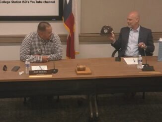 Screen shot from College Station ISD's YouTube channel showing (L-R) CSISD board president Jeff Horak and new superintendent Tim Harkrider, who is holding a new Texas A&M baseball cap, during the July 6, 2023 board meeting.