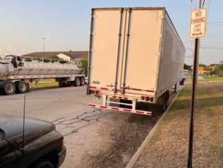 A pickup truck and a semi-trailer in the new no parking zone along Ponderosa in College Station, July 27, 2023.