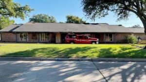 A Bryan fire marshal's pickup truck is parked in front of a fire damaged home at Rustling Oaks and Broadmoor on August 17, 2023.