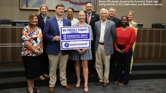 Bryan ISD photo taken September 25, 2023, showing Adam Foundation representatives (L-R) Colten Adam and Madison Januse holding a BISD "Essential Eight" sign.