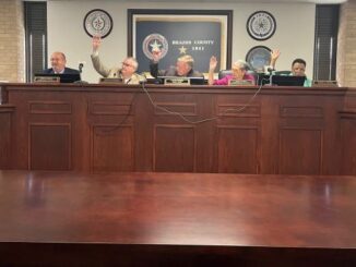 Raised hands by the Brazos County judge and three county commissioners voting for setting the proposed fiscal year 2024 tax rate during their September 5, 2023 meeting.