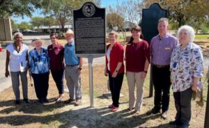 Members of the Brazos County Historical Commission gather next to a state historical marker that was unveiled at the 75th anniversary of the dedication of the College Station city cemetery on September 8, 2023.
