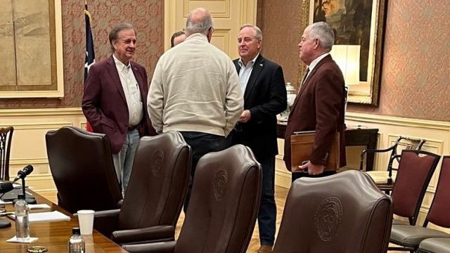 Following the Texas A&M system board of regents special meeting on November 17, 2023, a conversation involving (with his back turned) regent Sam Torn and (L-R) chancellor John Sharp, interim Texas A&M president Mark Welsh, and regent Randy Brooks.