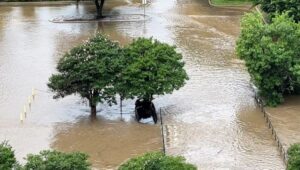 Vehicle in the flooded drainage ditch on the north side of Crystal Park Plaza/Guaranty Bank building, May 2, 2024.