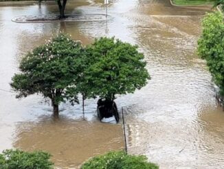 Vehicle in the flooded drainage ditch on the north side of Crystal Park Plaza/Guaranty Bank building, May 2, 2024.