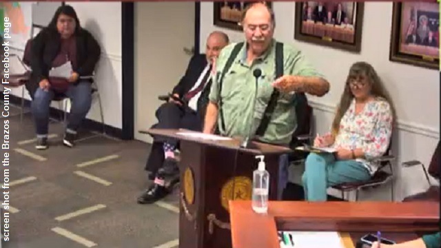 Screen shot from the Facebook video of the June 25, 2024 Brazos County commission meeting, where Charles G. Mancuso is holding a baggie of some of the bees that stung him, resulting in an ambulance taking him to a Bryan hospital.