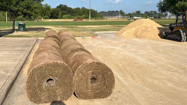 Rolls of sod and a mound of sand for repairing soccer fields at Veterans Park, August 22, 2024.